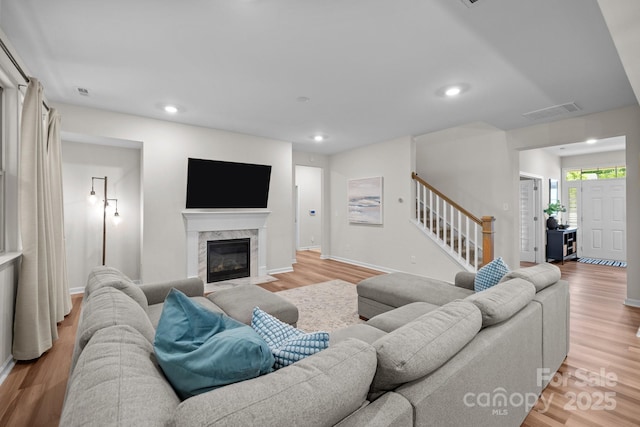 20307 Creek Bend Edge Ct Unit 10, Matthews, NC 28105 - living area featuring stairway, light wood-style flooring, a high end fireplace, and recessed lighting