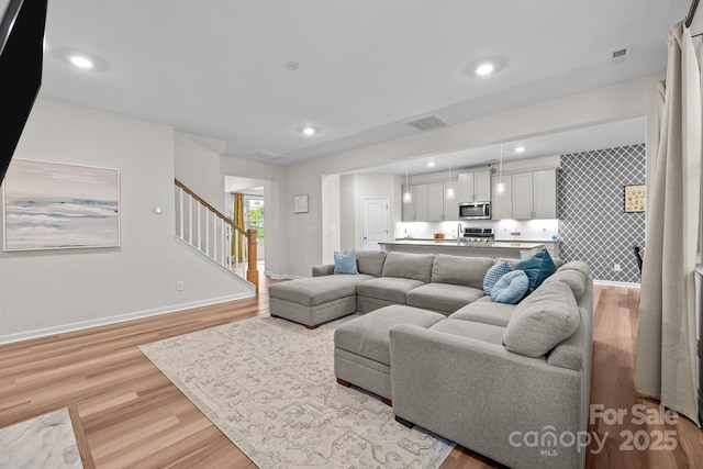 20307 Creek Bend Edge Ct Unit 10, Matthews, NC 28105 - living room with light wood-type flooring, stairway, and recessed lighting