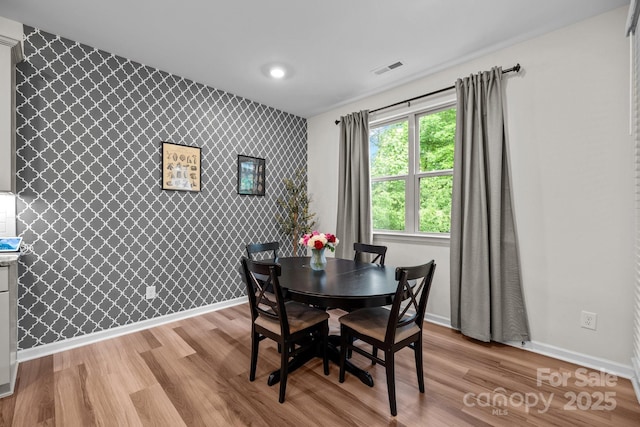 20307 Creek Bend Edge Ct Unit 10, Matthews, NC 28105 - dining room featuring an accent wall, light wood finished floors, wallpapered walls, and recessed lighting