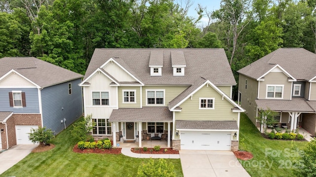 20307 Creek Bend Edge Ct Unit 10, Matthews, NC 28105 - craftsman-style home with a porch, driveway, an attached garage, stone siding, and a front lawn