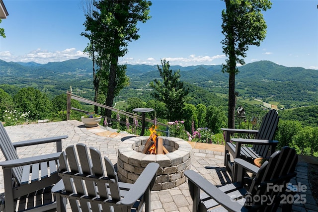 442 Signature Row Blvd, Waynesville, NC 28785 - view of patio featuring a fire pit, a mountain view, and a view of trees