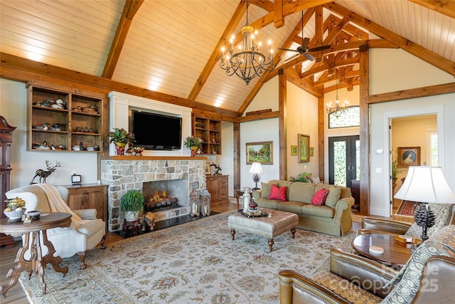 442 Signature Row Blvd, Waynesville, NC 28785 - living area with a chandelier, high vaulted ceiling, wood finished floors, a stone fireplace, and wooden ceiling with exposed beams