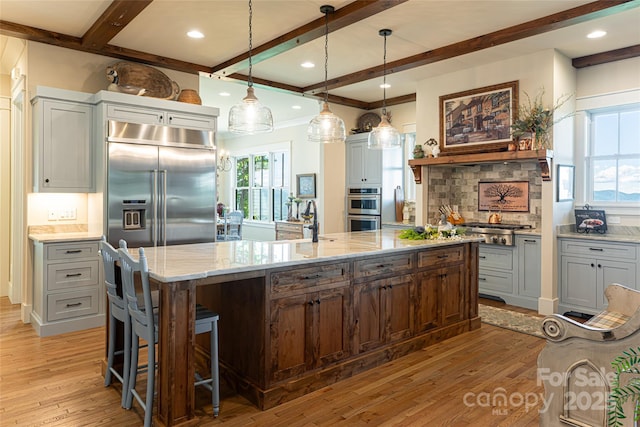 442 Signature Row Blvd, Waynesville, NC 28785 - kitchen with stainless steel appliances, beam ceiling, light wood-type flooring, decorative backsplash, and light stone counters