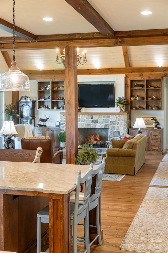 442 Signature Row Blvd, Waynesville, NC 28785 - dining room with beam ceiling, wood finished floors, and a stone fireplace