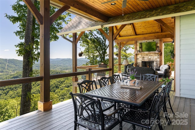 442 Signature Row Blvd, Waynesville, NC 28785 - wooden deck featuring a fireplace, outdoor dining space, and ceiling fan