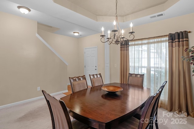 6104 Follow The Trl, Indian Trail, NC 28079 - dining room featuring a raised ceiling, a chandelier, light carpet, baseboards, and stairs