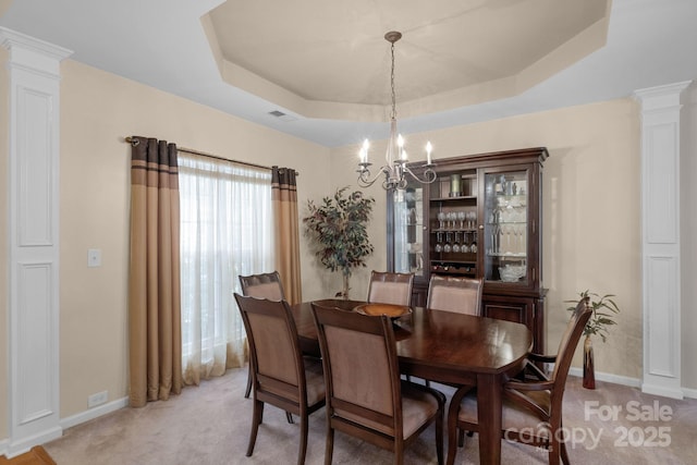 6104 Follow The Trl, Indian Trail, NC 28079 - dining space featuring decorative columns, a raised ceiling, a chandelier, and baseboards