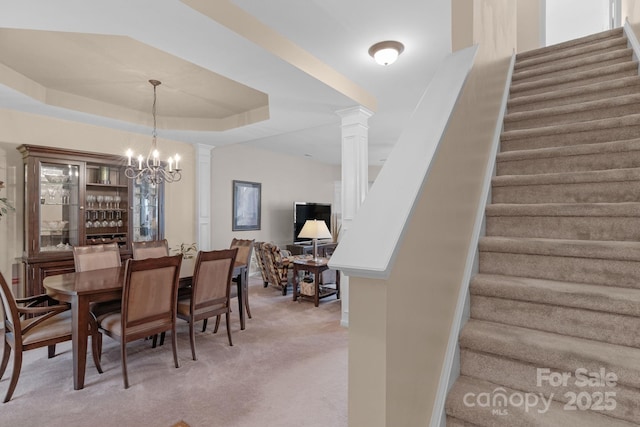 6104 Follow The Trl, Indian Trail, NC 28079 - dining area featuring stairs, decorative columns, light colored carpet, and a tray ceiling