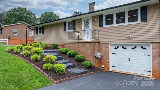 2401 Hillside Dr, Newton, NC 28658 - ranch-style house with an attached garage, a chimney, asphalt driveway, fence, and brick siding