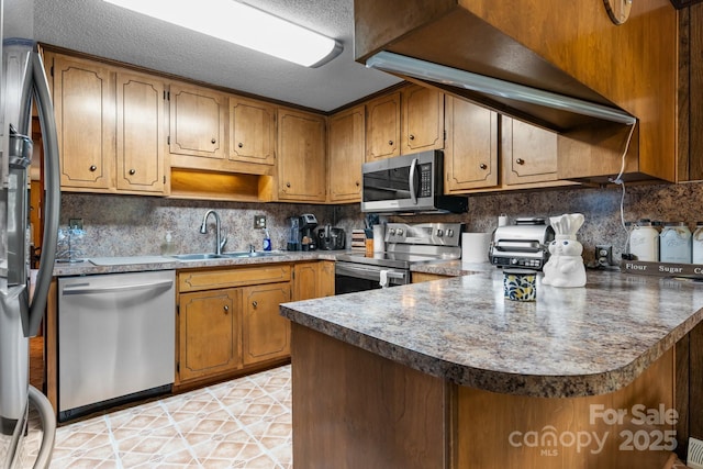 2401 Hillside Dr, Newton, NC 28658 - kitchen with appliances with stainless steel finishes, a sink, decorative backsplash, and brown cabinetry
