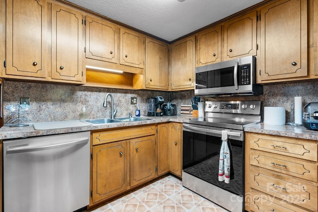 2401 Hillside Dr, Newton, NC 28658 - kitchen featuring appliances with stainless steel finishes, a sink, a textured ceiling, tasteful backsplash, and light countertops