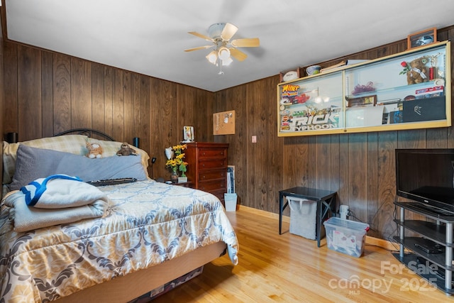 2401 Hillside Dr, Newton, NC 28658 - bedroom featuring wood finished floors, wood walls, and a ceiling fan