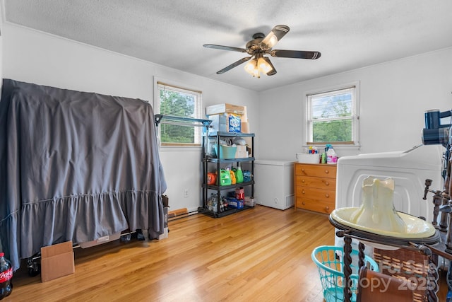 2401 Hillside Dr, Newton, NC 28658 - home office featuring washer / clothes dryer, light wood-style flooring, a ceiling fan, a textured ceiling, and crown molding