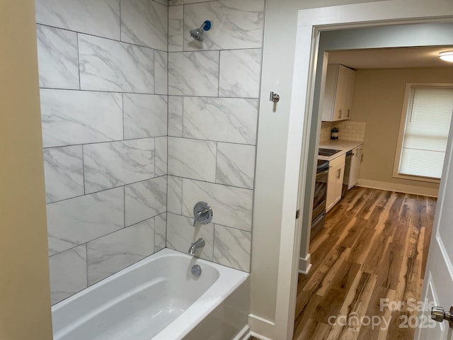 216 N Vance St, Gastonia, NC 28052 - bathroom featuring shower / bathtub combination, wood finished floors, backsplash, and vanity