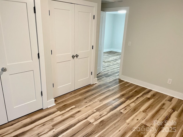 216 N Vance St, Gastonia, NC 28052 - unfurnished bedroom featuring light wood-style floors, baseboards, and a closet