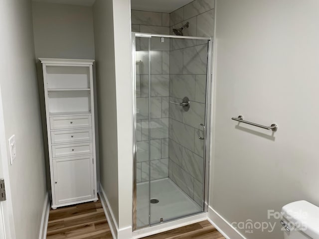 216 N Vance St, Gastonia, NC 28052 - full bathroom with wood finished floors, a shower stall, and toilet