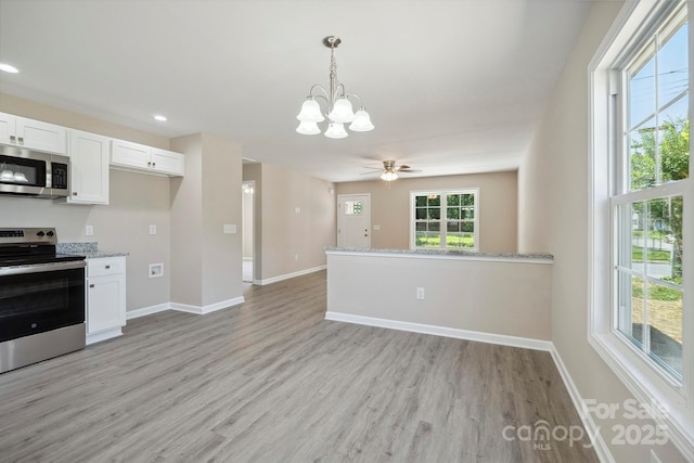 528 S Caldwell St, Salisbury, NC 28144 - kitchen featuring stainless steel appliances, a chandelier, light wood-style floors, white cabinets, and recessed lighting