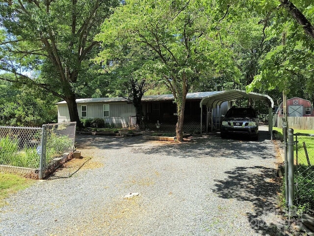 manufactured / mobile home featuring driveway and a carport