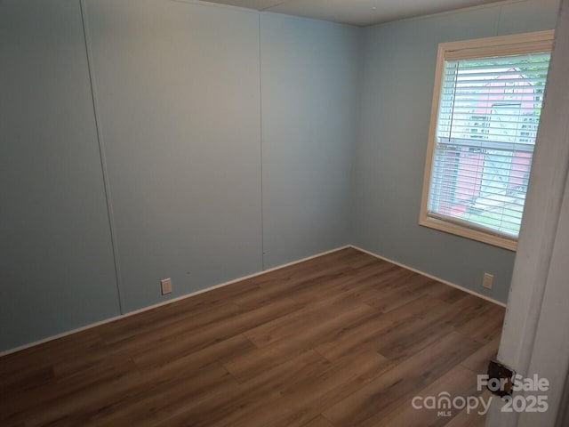 spare room featuring wood finished floors