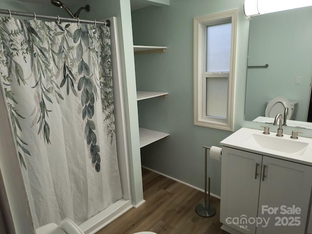 full bath with wood finished floors, vanity, and curtained shower