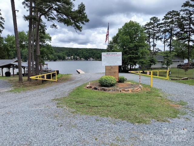 view of dirt / gravel driveway featuring a water view