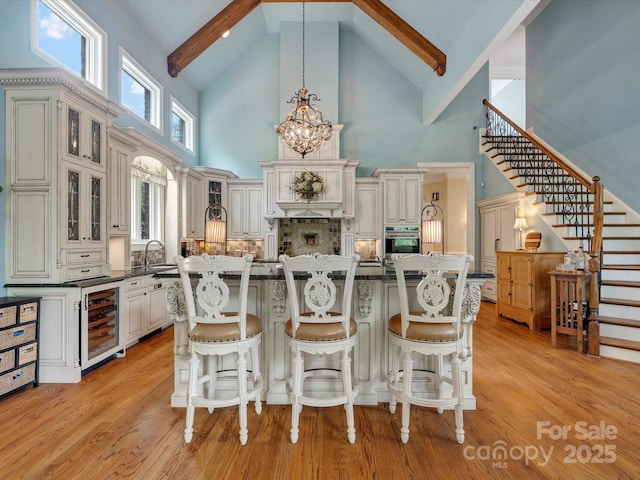 6742 Charlotte Hwy, York, SC 29745 - kitchen featuring high vaulted ceiling, beam ceiling, oven, beverage cooler, and dark countertops