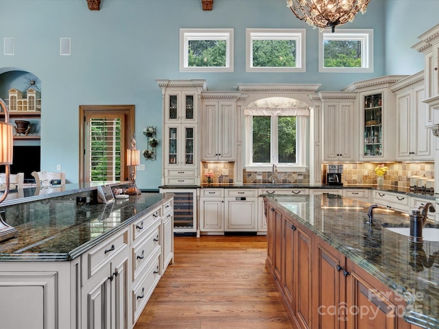 6742 Charlotte Hwy, York, SC 29745 - kitchen featuring wine cooler, a high ceiling, dark stone counters, and decorative backsplash