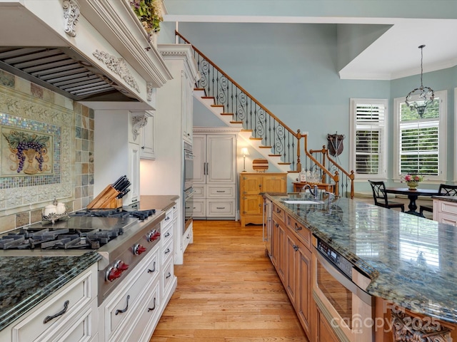 6742 Charlotte Hwy, York, SC 29745 - kitchen with extractor fan, stainless steel appliances, a sink, decorative backsplash, and light wood finished floors
