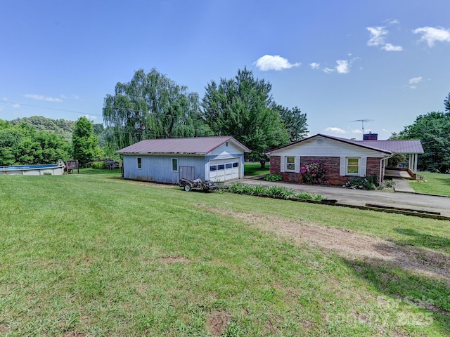 522 Bailey Mountain Rd, Mars Hill, NC 28754 - view of home's exterior with metal roof, a detached garage, an outbuilding, a pool, and a yard