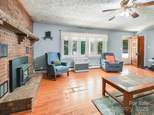 522 Bailey Mountain Rd, Mars Hill, NC 28754 - living room featuring light wood-type flooring, a textured ceiling, ceiling fan, and baseboard heating