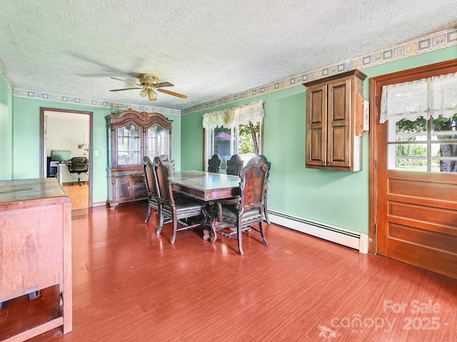 522 Bailey Mountain Rd, Mars Hill, NC 28754 - dining room featuring a baseboard heating unit, wood finished floors, ceiling fan, a textured ceiling, and plenty of natural light