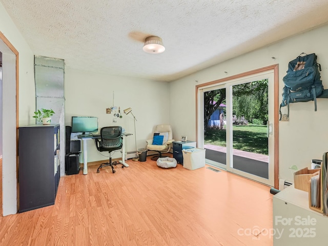 522 Bailey Mountain Rd, Mars Hill, NC 28754 - office featuring wood finished floors, a textured ceiling, a baseboard heating unit, and baseboard heating