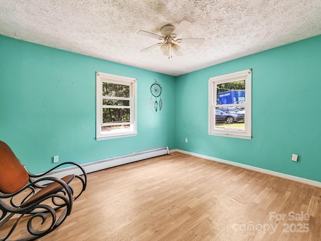 522 Bailey Mountain Rd, Mars Hill, NC 28754 - spare room with healthy amount of natural light, wood finished floors, a ceiling fan, and a textured ceiling