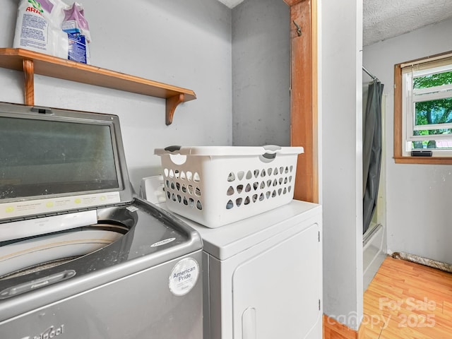 522 Bailey Mountain Rd, Mars Hill, NC 28754 - laundry area featuring washer and clothes dryer, light wood-type flooring, and a textured ceiling