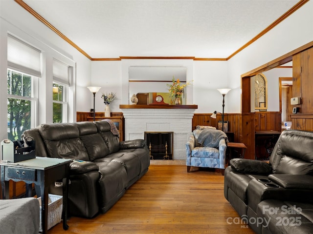 6 Woodley Ave, Asheville, NC 28804 - living area featuring ornamental molding, wood finished floors, wainscoting, a brick fireplace, and wood walls