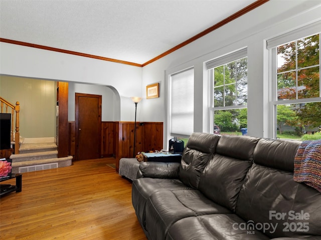 6 Woodley Ave, Asheville, NC 28804 - living room with ornamental molding, light wood-style flooring, stairs, wooden walls, and wainscoting