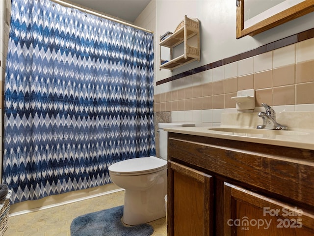 6 Woodley Ave, Asheville, NC 28804 - bathroom featuring a shower with shower curtain, vanity, tile walls, toilet, and tile patterned flooring
