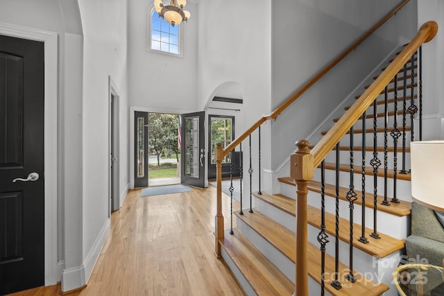 389 Ponderosa Cir, Mooresville, NC 28117 - entrance foyer featuring wood finished floors, stairs, a high ceiling, and baseboards
