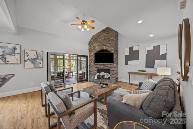 389 Ponderosa Cir, Mooresville, NC 28117 - living room with ceiling fan, baseboards, light wood-type flooring, a stone fireplace, and high vaulted ceiling