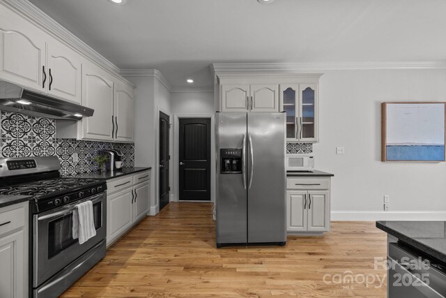 389 Ponderosa Cir, Mooresville, NC 28117 - kitchen with appliances with stainless steel finishes, under cabinet range hood, ornamental molding, recessed lighting, and tasteful backsplash