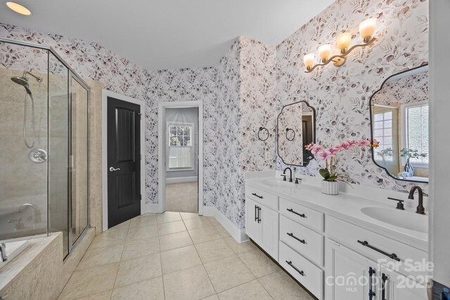 389 Ponderosa Cir, Mooresville, NC 28117 - full bath featuring a stall shower, double vanity, tile patterned flooring, wallpapered walls, and baseboards