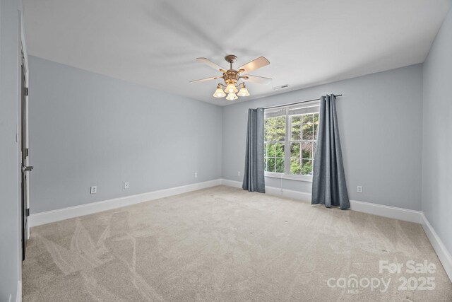 389 Ponderosa Cir, Mooresville, NC 28117 - carpeted spare room with baseboards and a ceiling fan