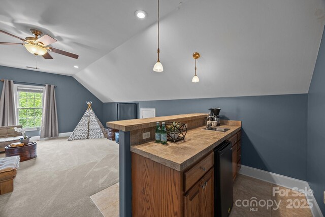 389 Ponderosa Cir, Mooresville, NC 28117 - kitchen featuring a sink, vaulted ceiling, ceiling fan, baseboards, and a peninsula