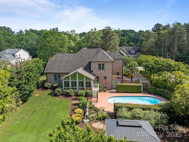 389 Ponderosa Cir, Mooresville, NC 28117 - view of swimming pool featuring a sunroom, a patio, and a view of trees