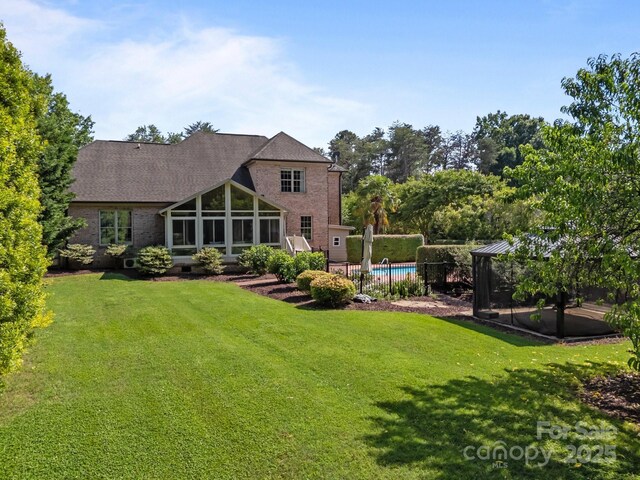 389 Ponderosa Cir, Mooresville, NC 28117 - back of house with a sunroom and brick siding