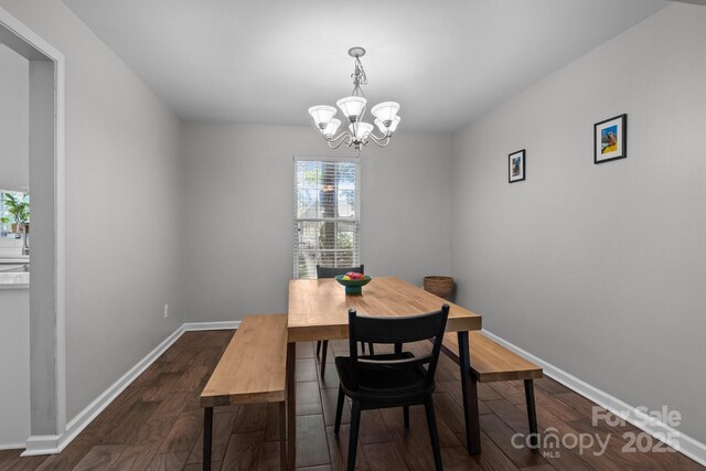 10327 Shelter Rock Ct, Charlotte, NC 28214 - dining room featuring a chandelier, dark wood-style flooring, and baseboards