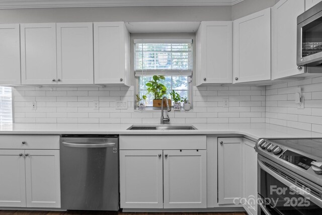 10327 Shelter Rock Ct, Charlotte, NC 28214 - kitchen with appliances with stainless steel finishes, a sink, light countertops, white cabinets, and tasteful backsplash