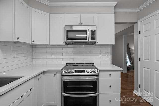 10327 Shelter Rock Ct, Charlotte, NC 28214 - kitchen featuring stainless steel appliances, crown molding, light countertops, dark wood-type flooring, and white cabinets