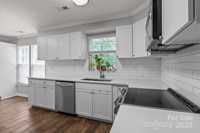 10327 Shelter Rock Ct, Charlotte, NC 28214 - kitchen featuring appliances with stainless steel finishes, a sink, ornamental molding, backsplash, and white cabinets