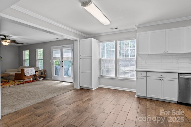 10327 Shelter Rock Ct, Charlotte, NC 28214 - kitchen with dishwasher, light wood-type flooring, backsplash, white cabinetry, and a ceiling fan